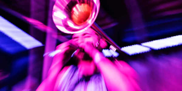 Pink and Purple Overlay Image of trumpet player at Blues Fest