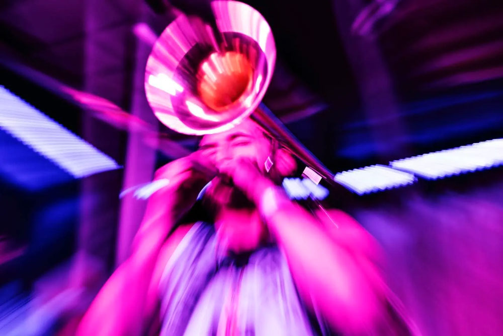 Pink and Purple Overlay Image of trumpet player at Blues Fest